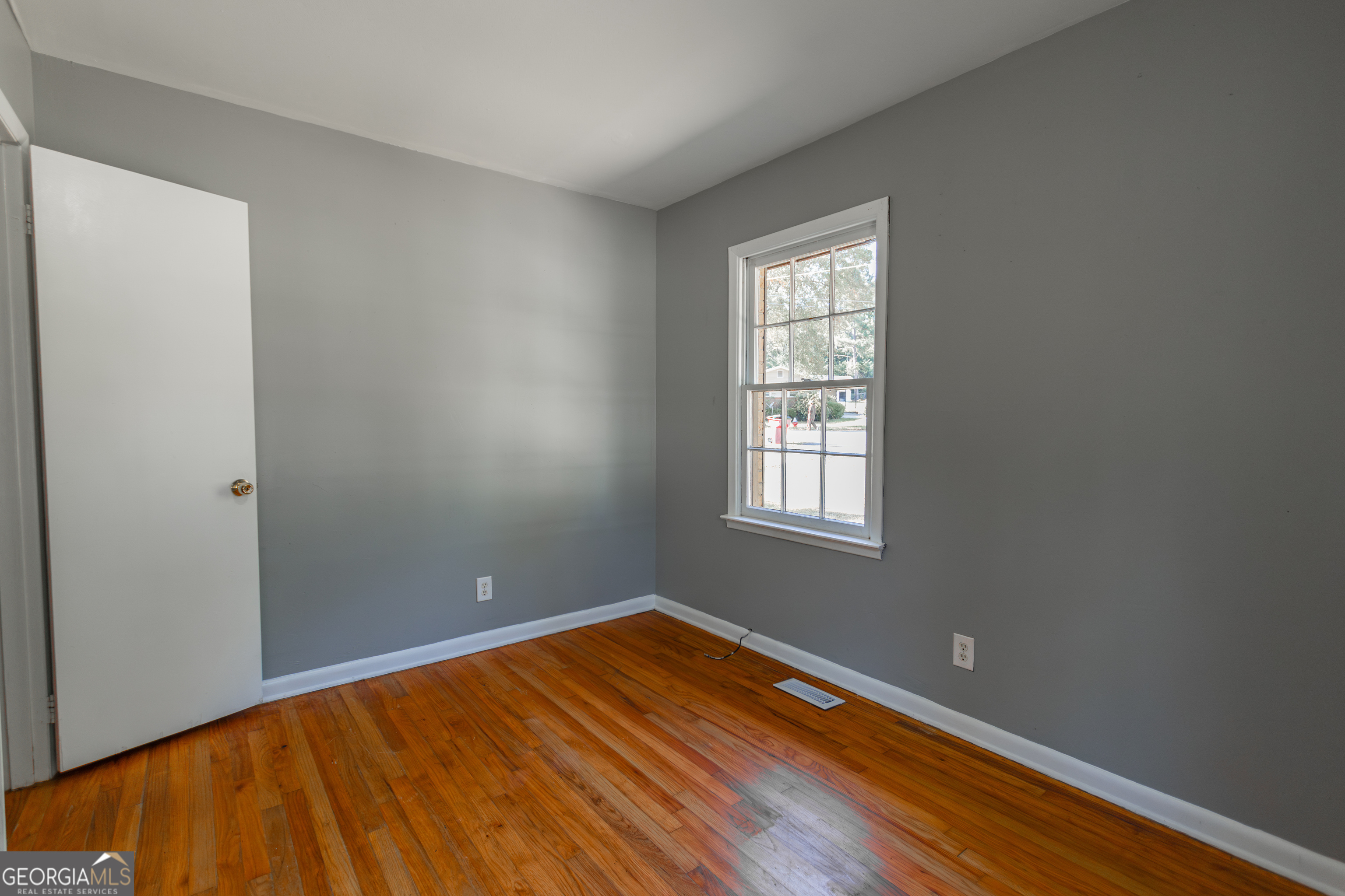 208 Bassett Street Centerville, GA 31028 - Photo 21 of 24 a view of empty room with wooden floor and fan
