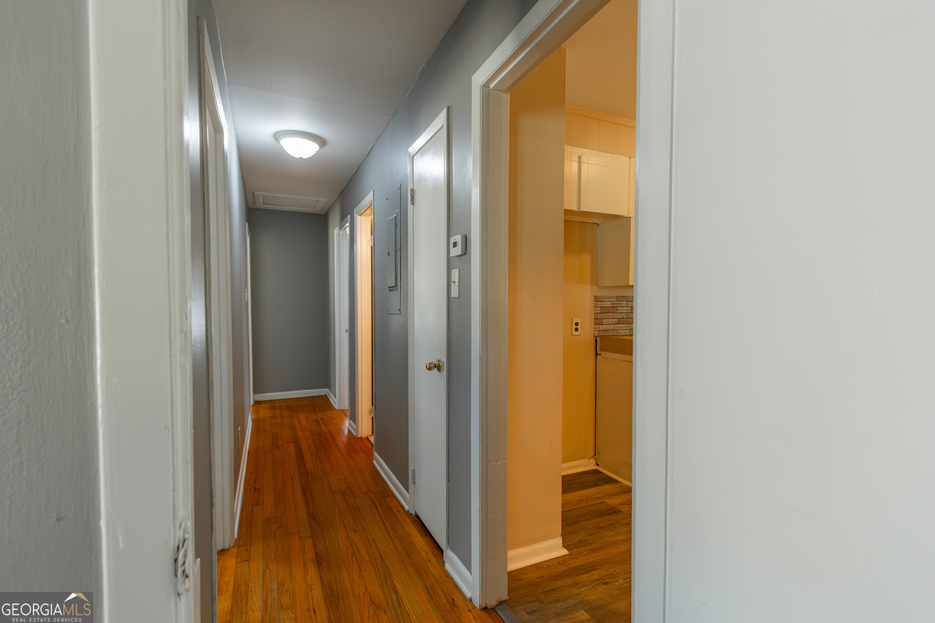 208 Bassett Street Centerville, GA 31028 - Photo 22 of 24 a view of a hallway with wooden floor