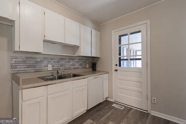 a kitchen with a sink and cabinets