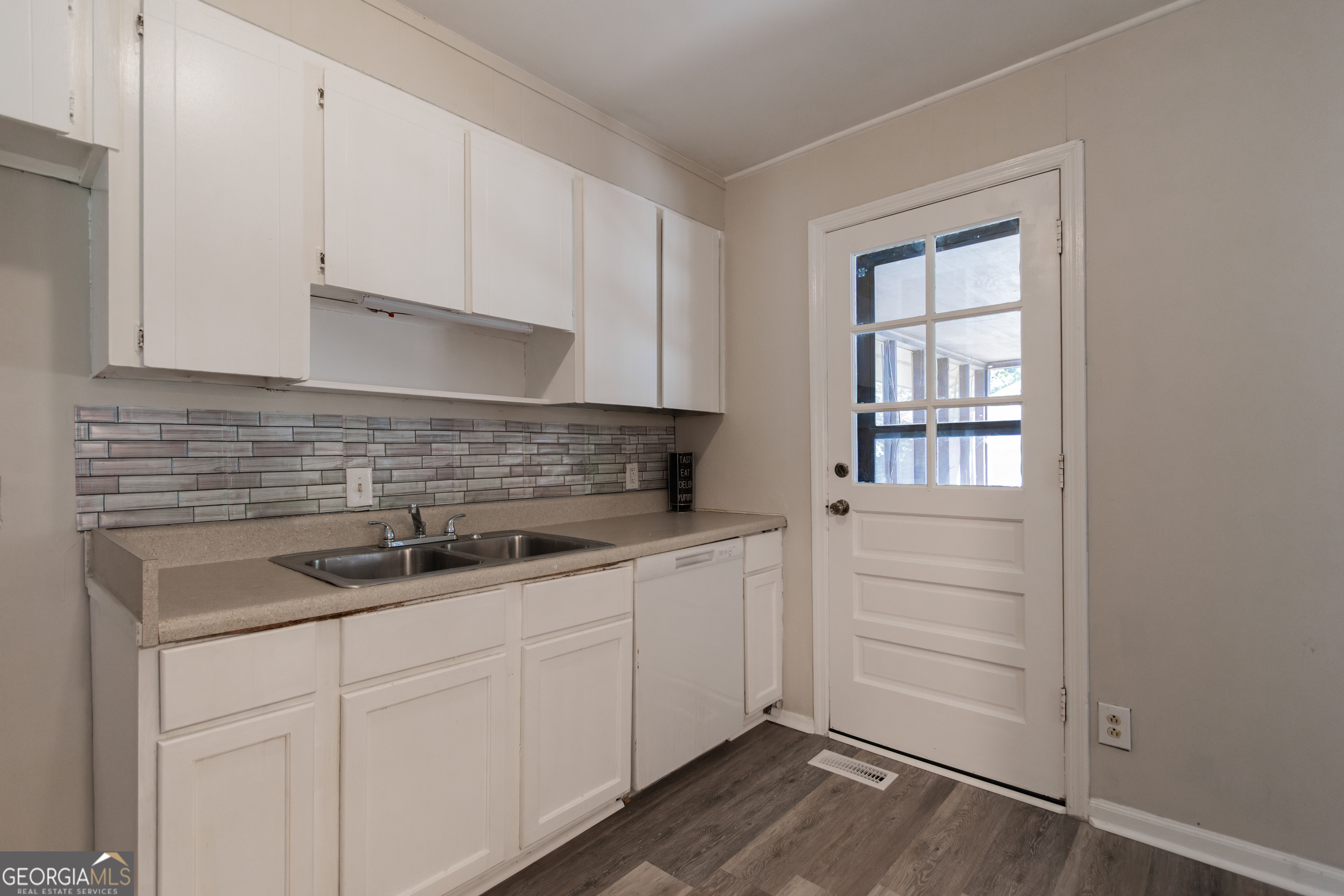 208 Bassett Street Centerville, GA 31028 - Photo 23 of 24 a kitchen with a sink and cabinets