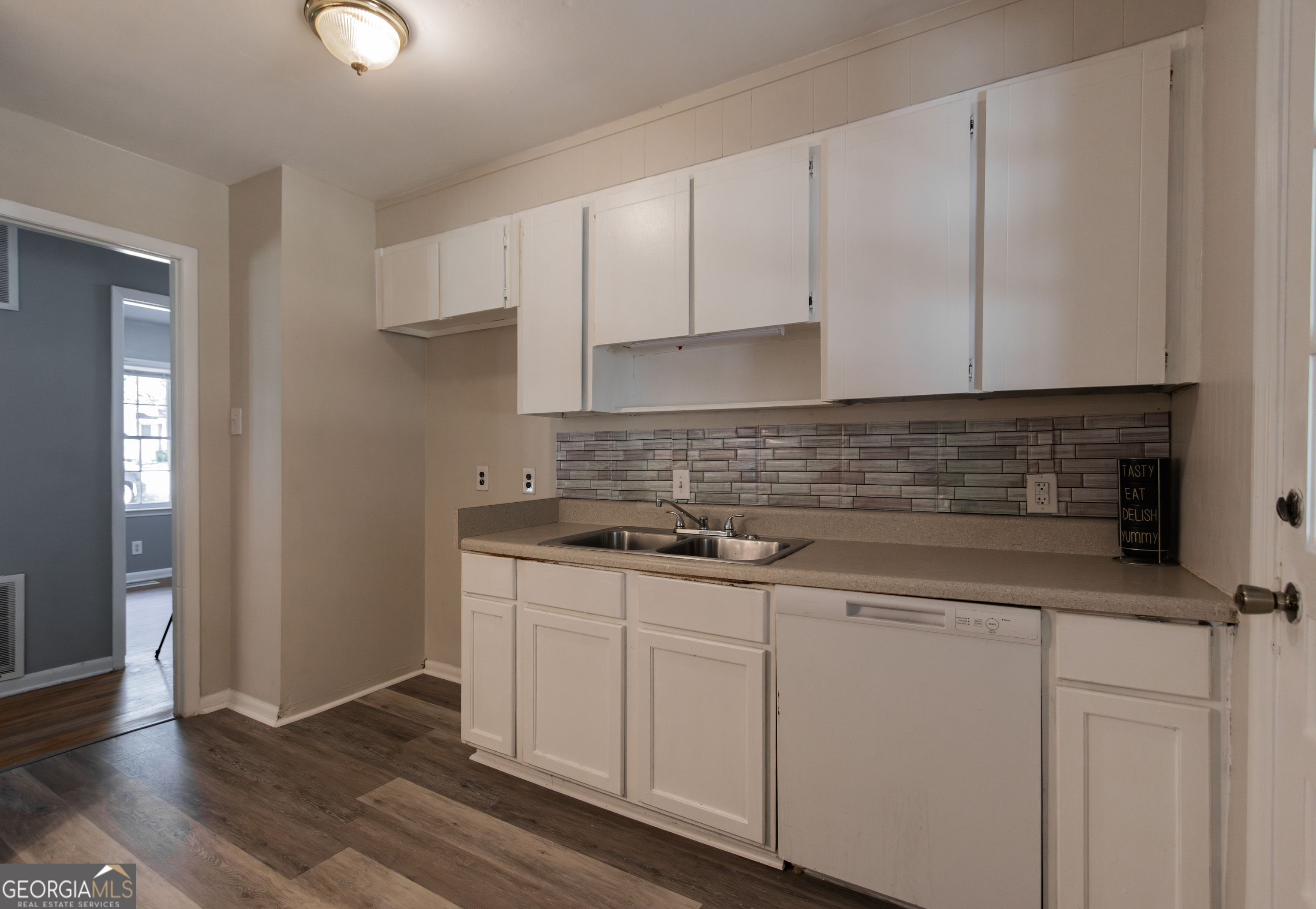 208 Bassett Street Centerville, GA 31028 - Photo 24 of 24 a kitchen with granite countertop white cabinets and a stove