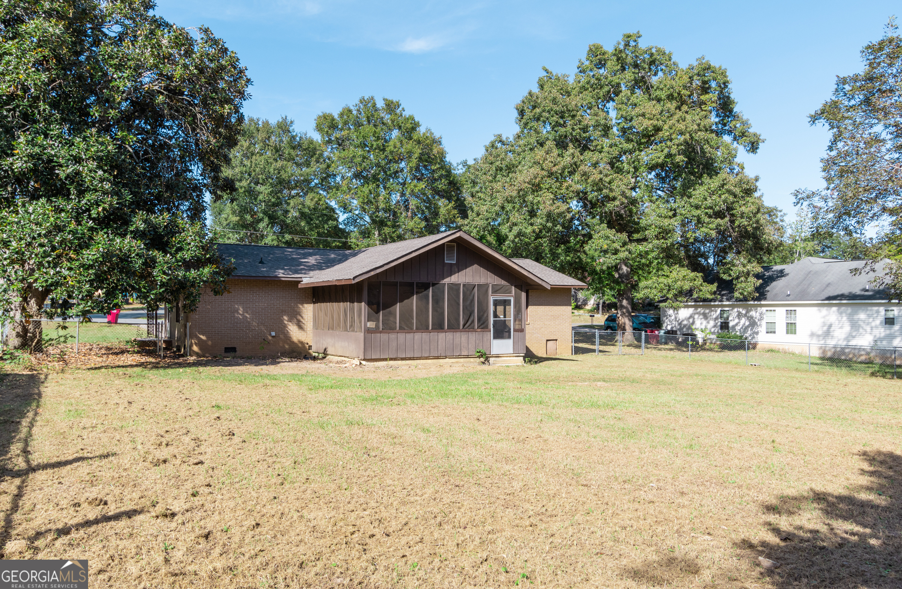 208 Bassett Street Centerville, GA 31028 - Photo 3 of 24 a wooden house with a big yard and large trees