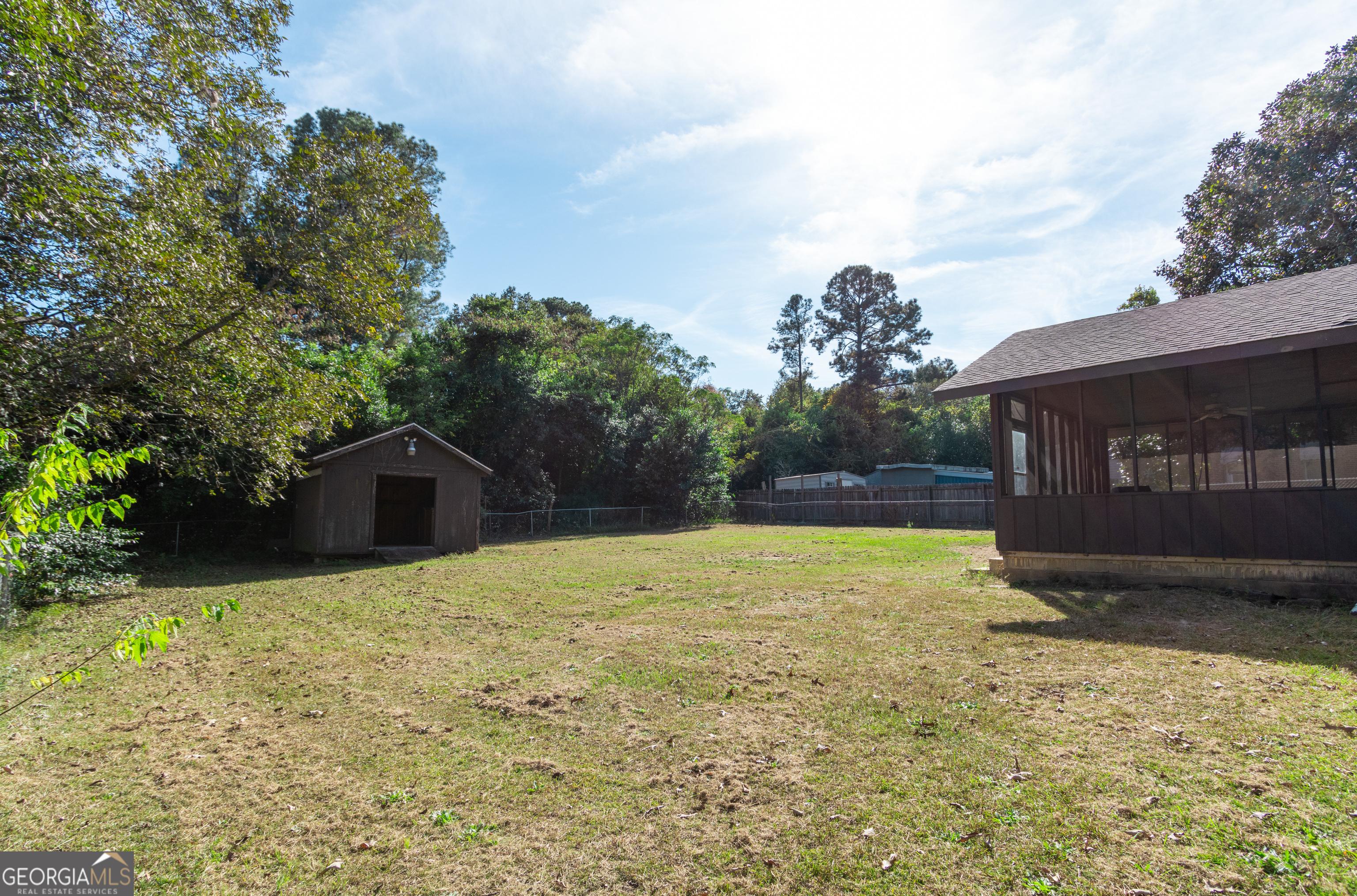 208 Bassett Street Centerville, GA 31028 - Photo 6 of 24 a tall yellow house with a yard in front of it