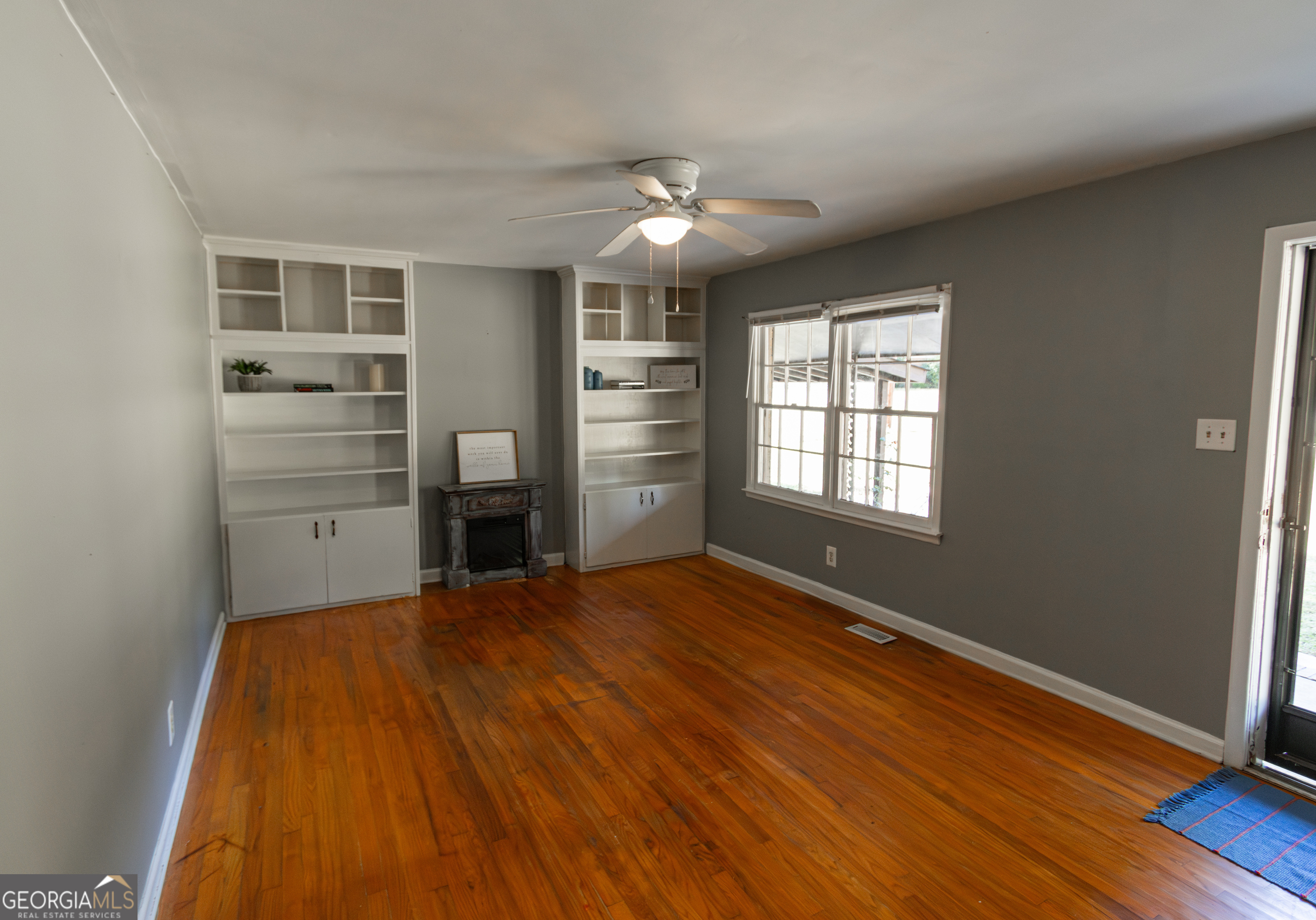 208 Bassett Street Centerville, GA 31028 - Photo 10 of 24 a view of empty room with wooden floor and fan