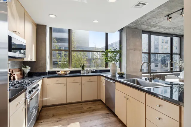 a kitchen with stainless steel appliances a sink stove and cabinets