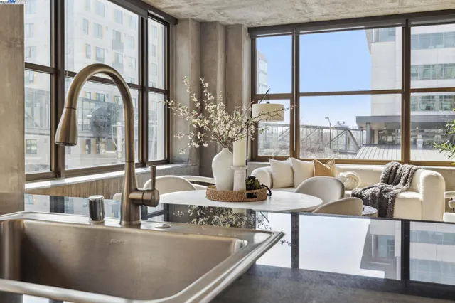 a view of living room filled with furniture and floor to ceiling windows
