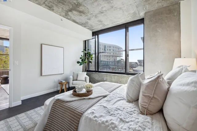 a bedroom with bed and a large window