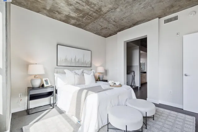 a bedroom with a bed and a lamp on table