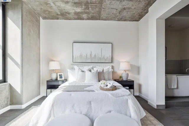 a bedroom with a bed and a night stand