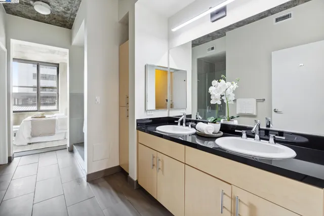 a en suite bathroom with double sink and a mirror