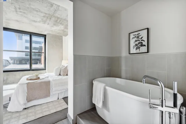 a white bath tub sitting next to a white wall