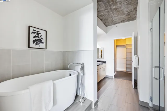 a bathroom with a bathtub and a hallway