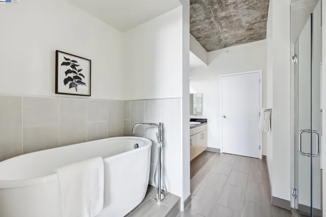 a bathroom with a bathtub and a hallway