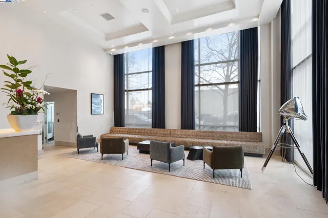 a living room filled with furniture and a potted plant