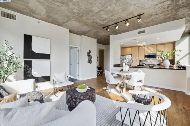 a living room with furniture and kitchen view