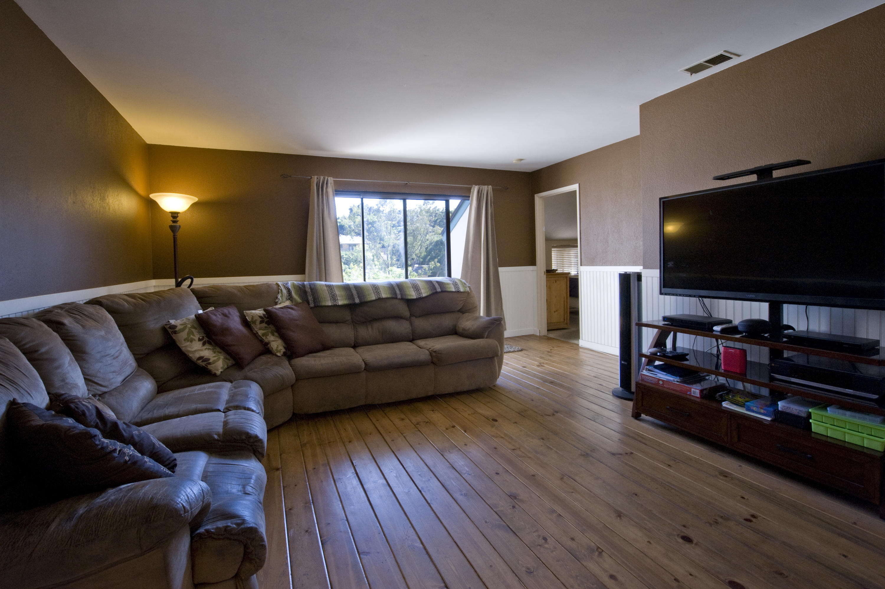 3558 Modoc Road, Unit 37 Santa Barbara, CA 93105 - Photo 1 of 12 a living room with furniture and a flat screen tv