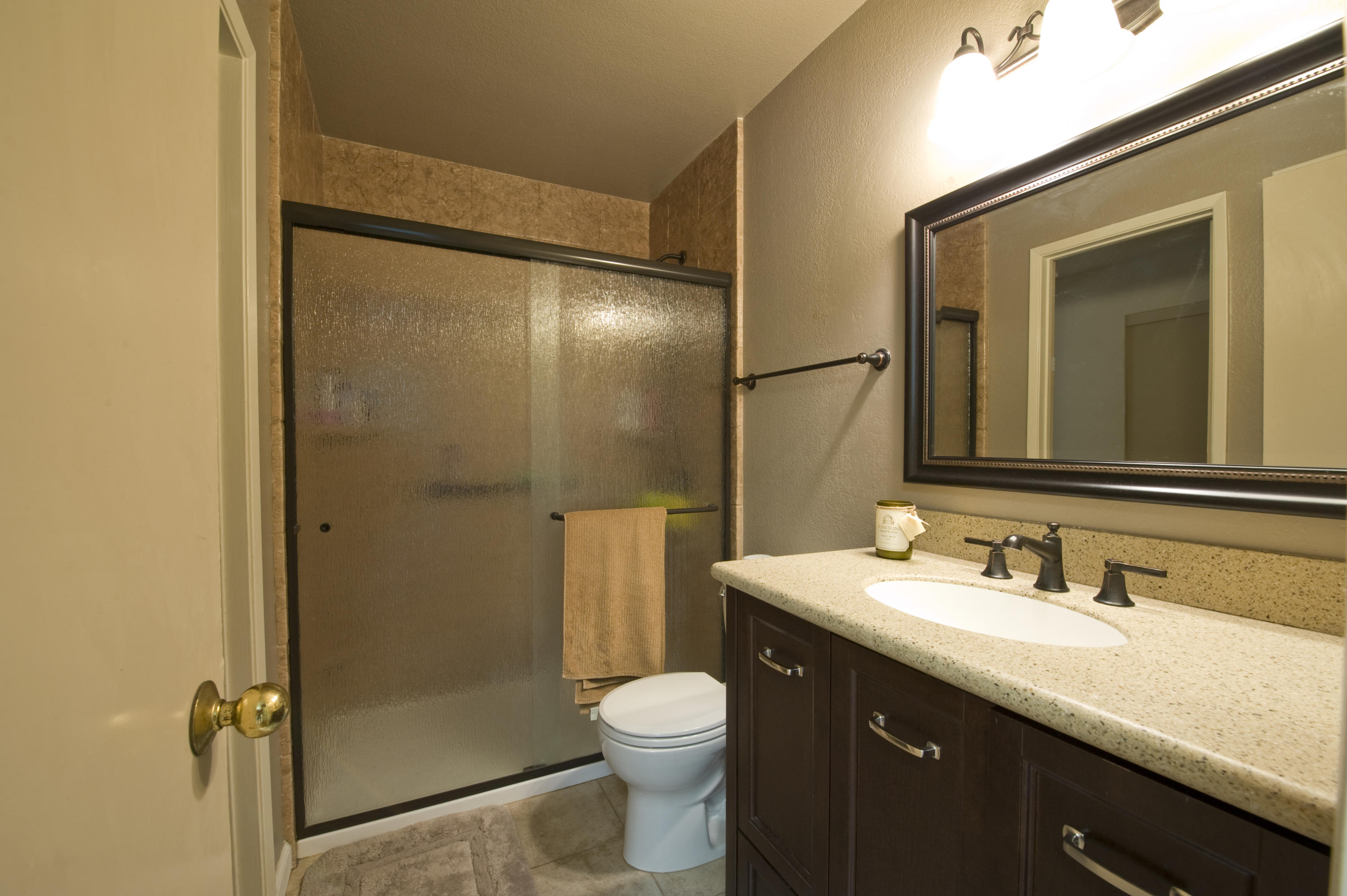 3558 Modoc Road, Unit 37 Santa Barbara, CA 93105 - Photo 8 of 12 a bathroom with a granite countertop toilet sink shower and mirror