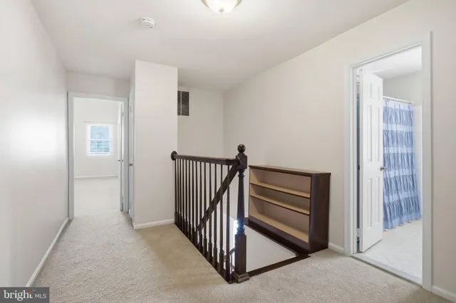 a view of a hallway with entryway doors