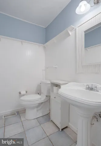 a bathroom with a sink toilet and vanity
