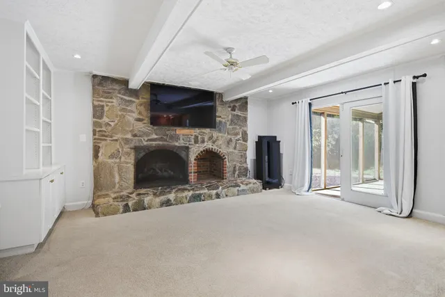 a view of a livingroom with an empty space and a fireplace