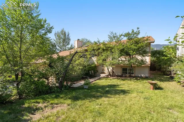 a view of a house with a yard and sitting area