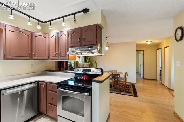 a kitchen with a stove sink and cabinets