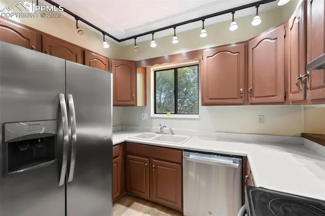 a kitchen with stainless steel appliances a stove a sink and cabinets