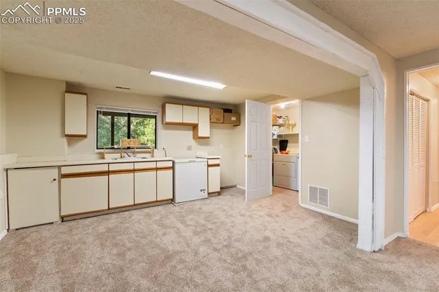 a kitchen with sink cabinets and window