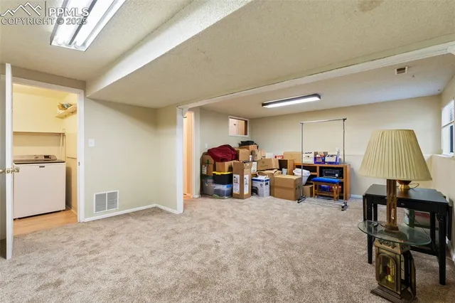 a living room with furniture and a lamp