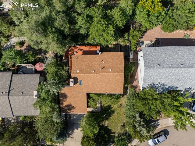 an aerial view of a house with a yard and lake view