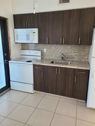 a kitchen with a cabinets and a stove top oven