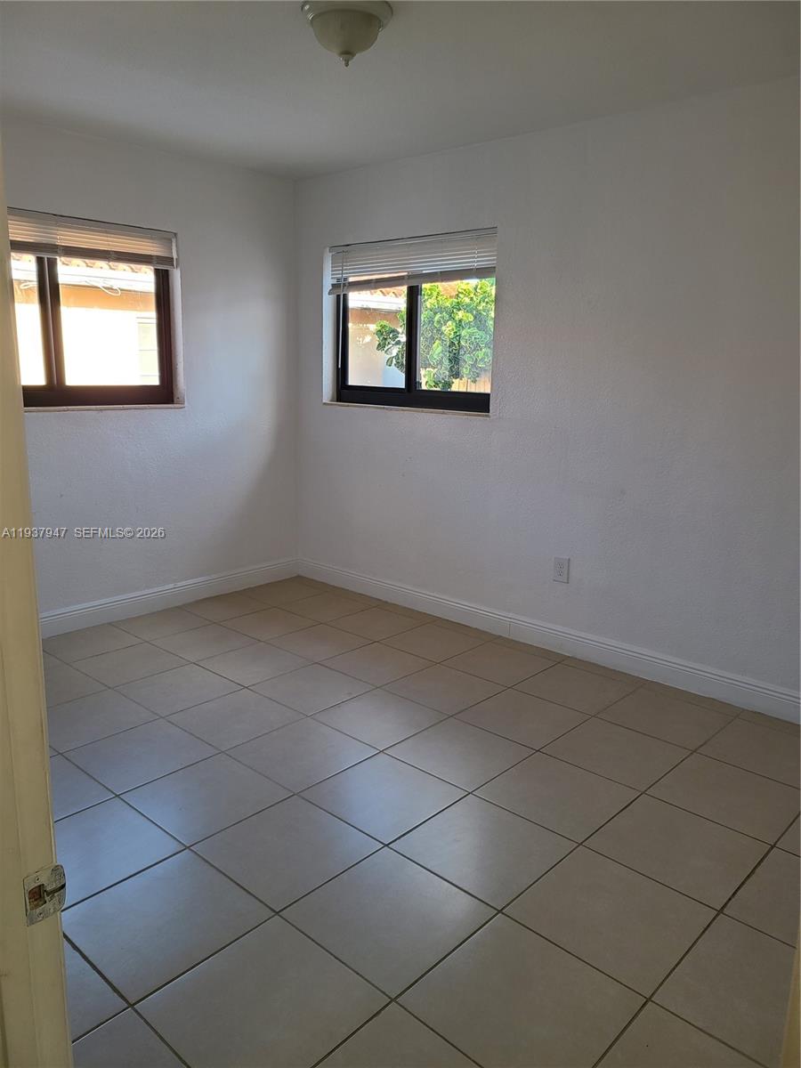310-312 Southwest 36th Avenue Miami, FL 33135 - Photo 14 of 15 en empty room with windows