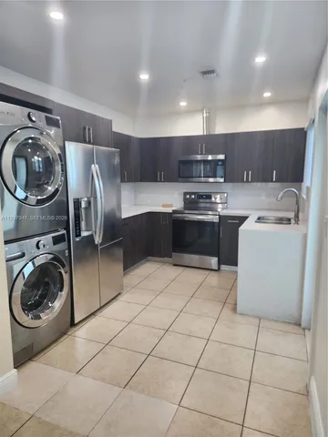 a kitchen with a sink a washer and dryer