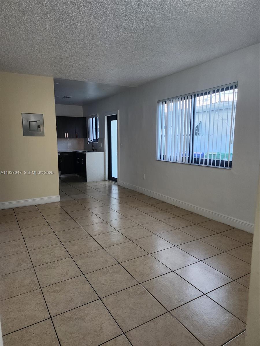 310-312 Southwest 36th Avenue Miami, FL 33135 - Photo 5 of 15 a view of an empty room with a window