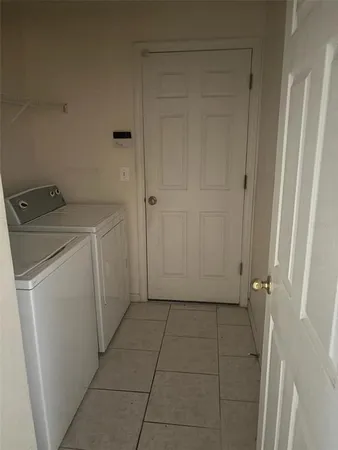 a view of a storage & utility room with a washer dryer