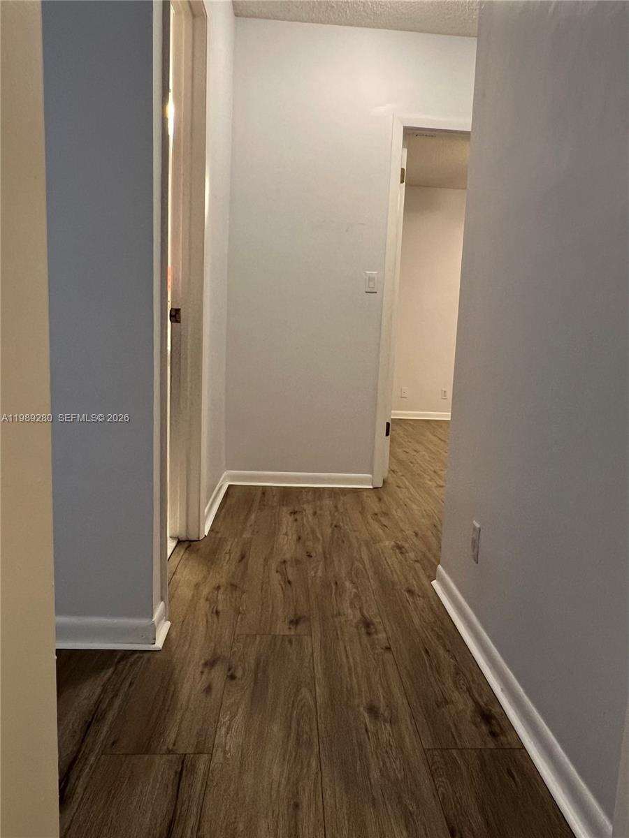 543 Racquet Club Road, Unit 33 Weston, FL 33326 - Photo 21 of 28 wooden floor in a gallery