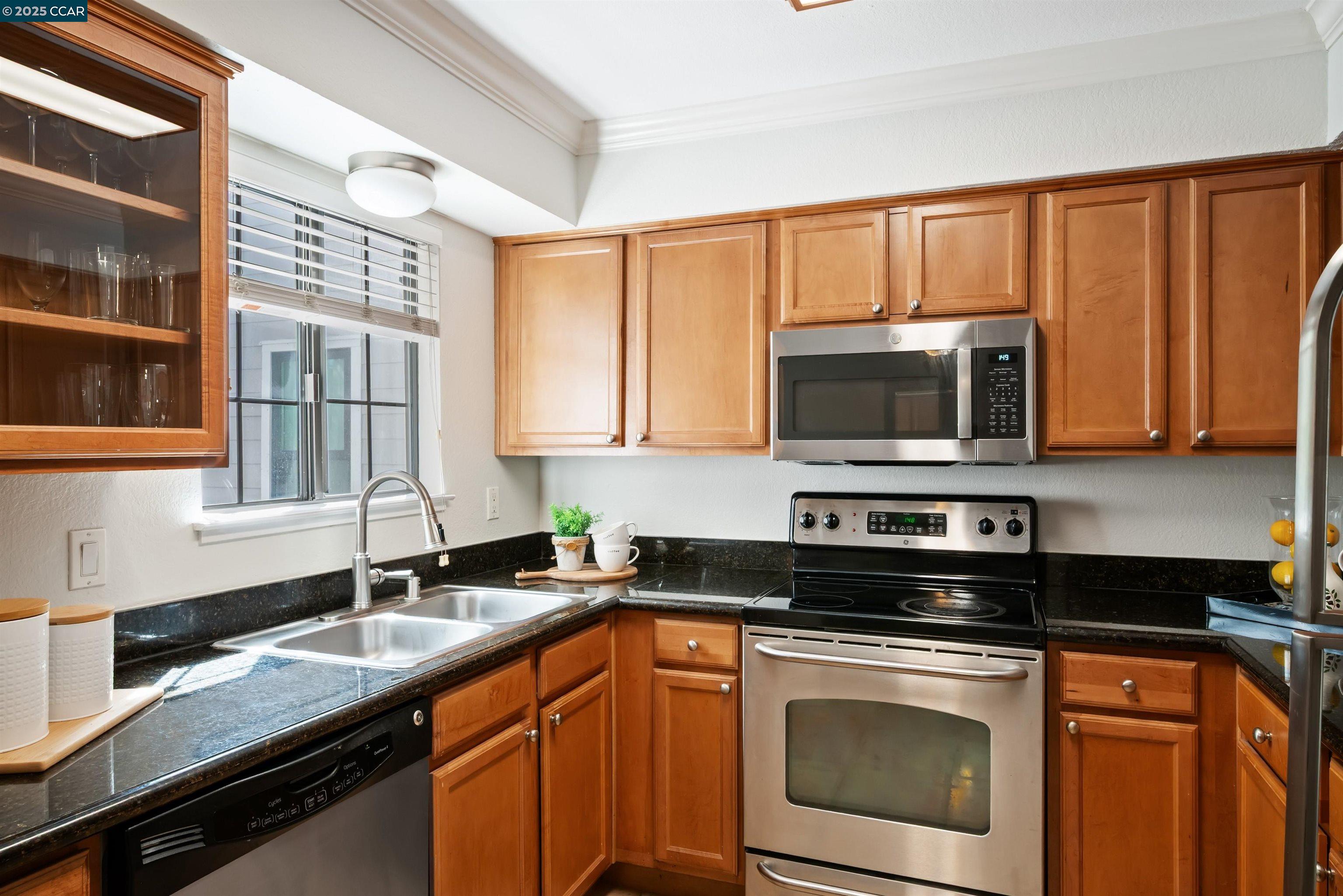 332 Eastridge Drive San Ramon, CA 94582 - Photo 15 of 36 a kitchen with stainless steel appliances granite countertop a sink stove and microwave