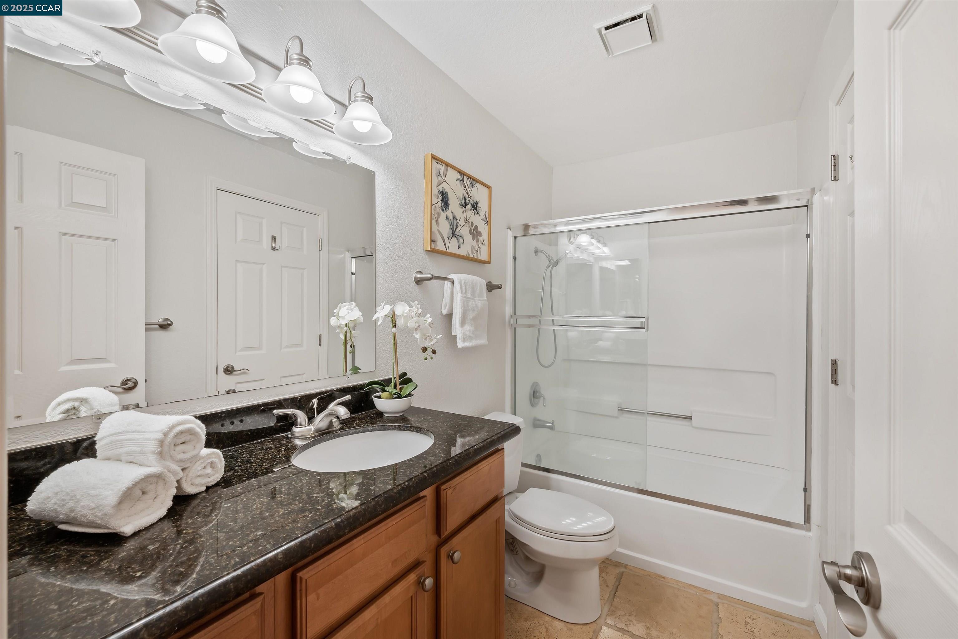 332 Eastridge Drive San Ramon, CA 94582 - Photo 26 of 36 a bathroom with a granite countertop sink a toilet and shower