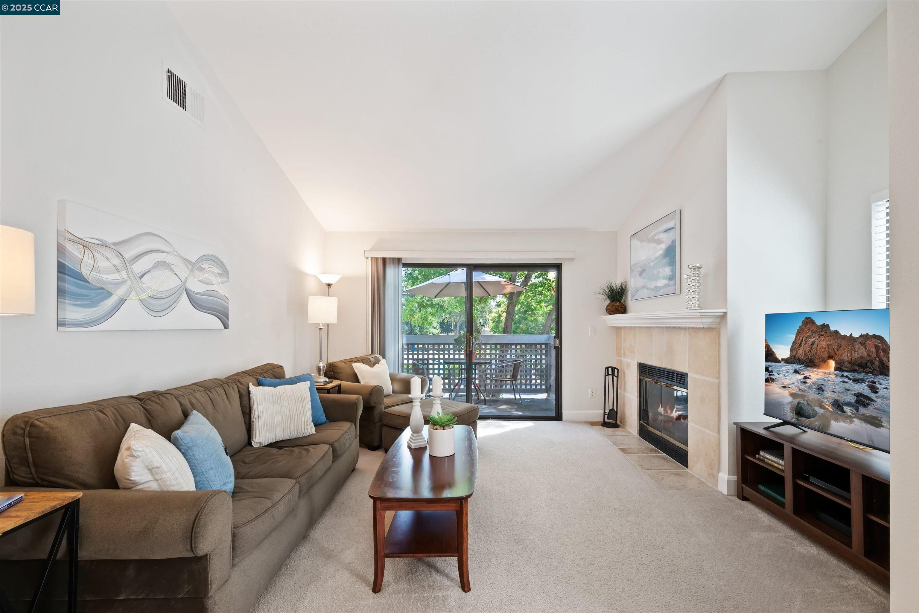 332 Eastridge Drive San Ramon, CA 94582 - Photo 9 of 36 a living room with furniture a fireplace and a floor to ceiling window
