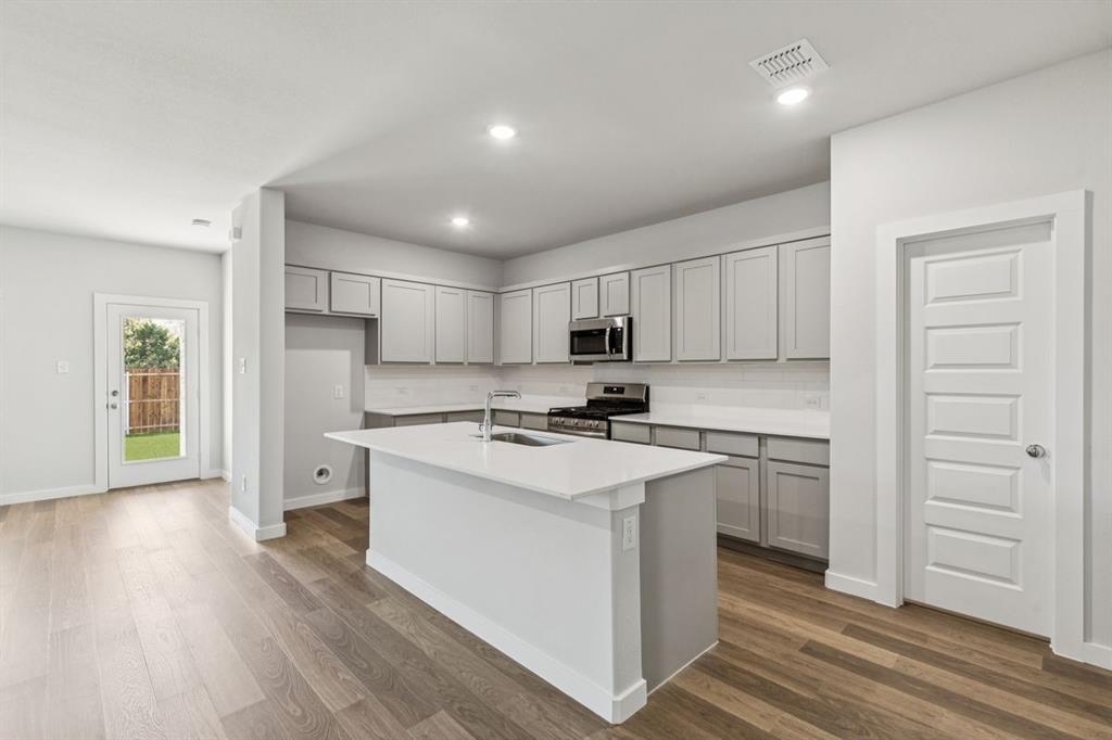 361 Yellowstar Lane Lavon, TX 75166 - Photo 9 of 33 Kitchen in the Oscar home plan by Trophy Signature Homes – REPRESENTATIVE PHOTO