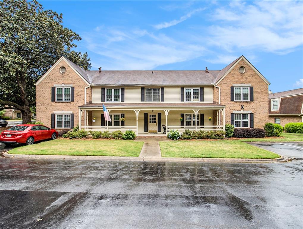 3825 Lavista Road, Unit X2 Tucker, GA 30084 - Photo 1 of 1 a front view of a house with a yard and porch
