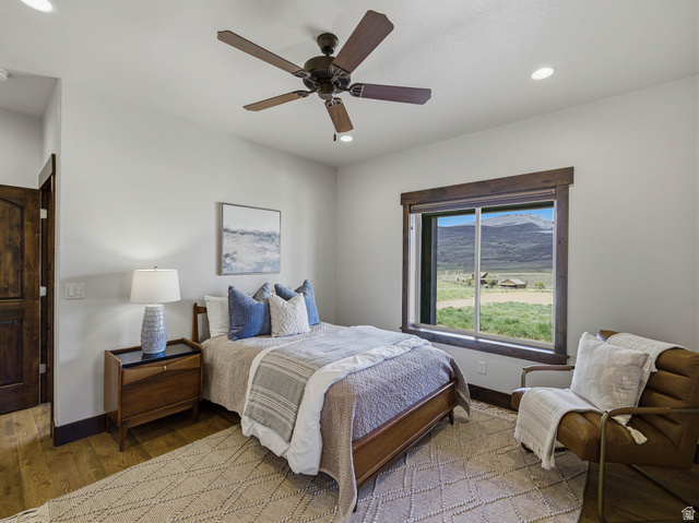 402 Shadow Hill Road Wanship, UT 84017 - Photo 31 of 90 Bedroom with wood finished floors, a mountain view, a ceiling fan, and recessed lighting
