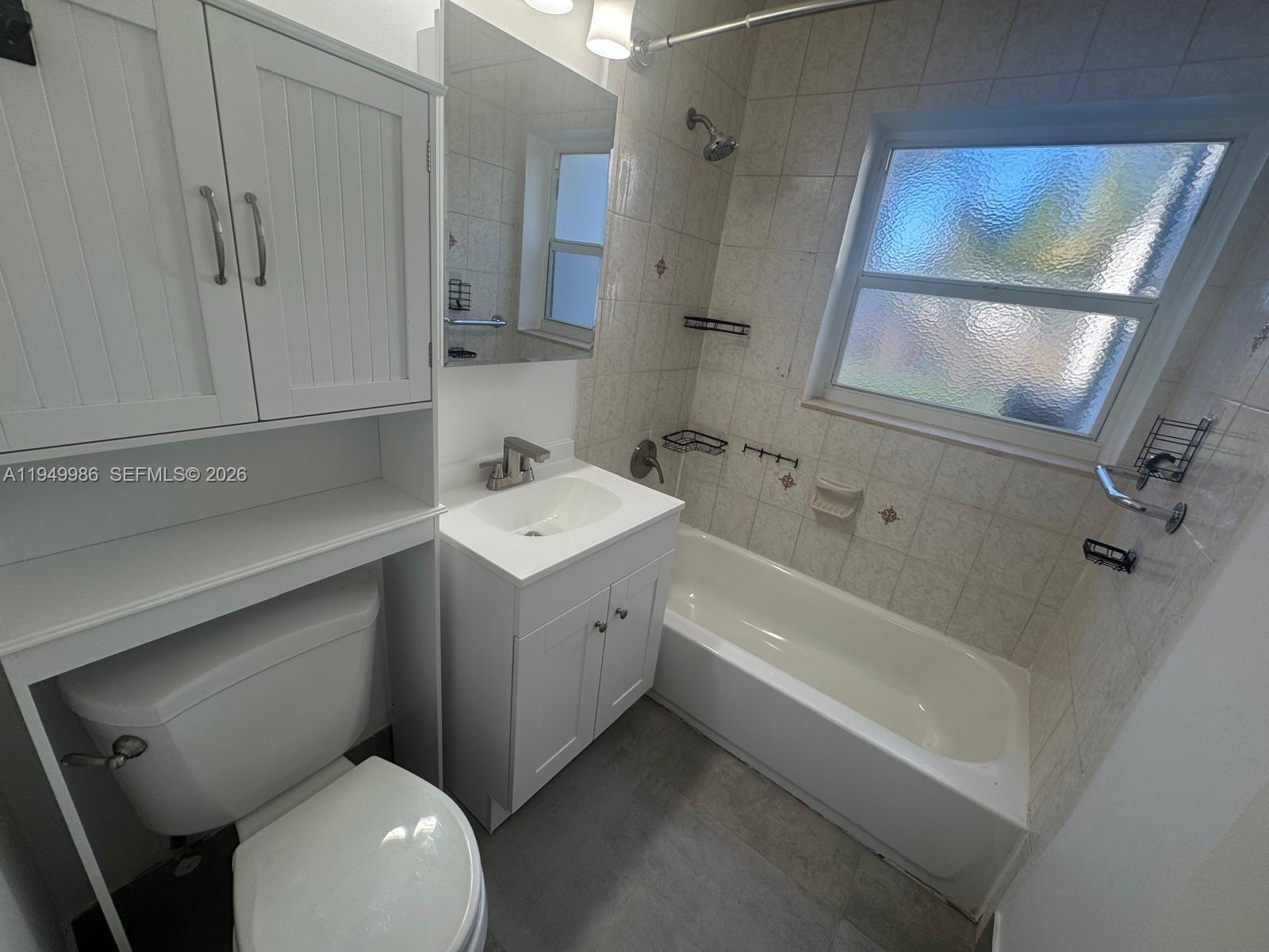 1631 Rodman Street, Unit 1631 Hollywood, FL 33020 - Photo 4 of 7 a bathroom with a sink toilet and shower