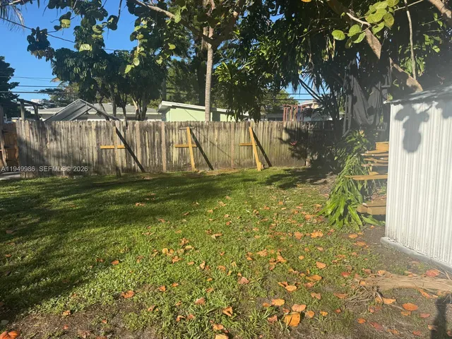 a view of a yard with a tree