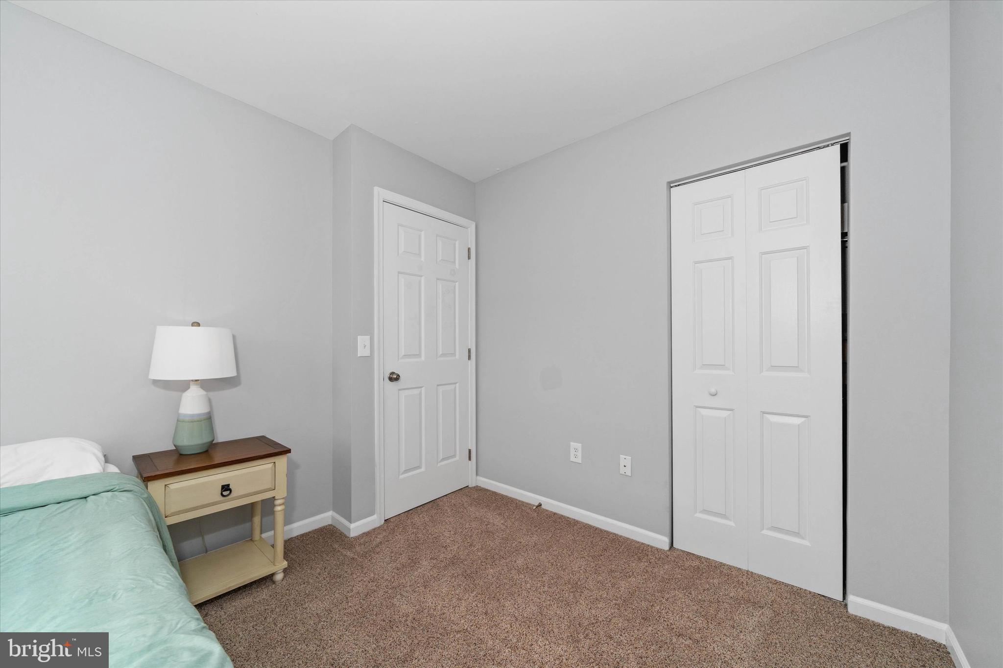 337 Norman Drive Newark, DE 19702 - Photo 24 of 33 a view of a room that has a bed and a lamp on the table