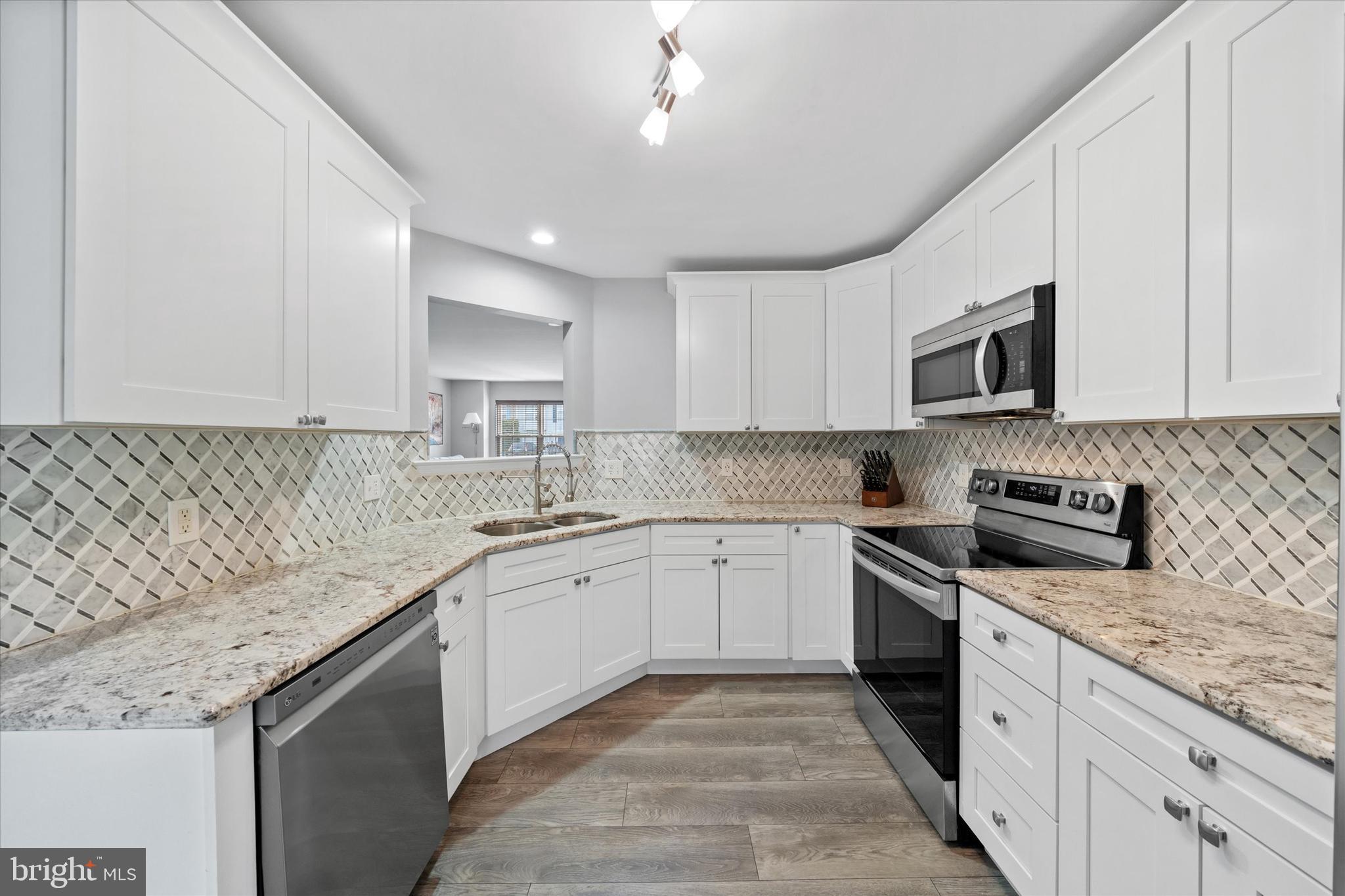 337 Norman Drive Newark, DE 19702 - Photo 10 of 33 a kitchen with stainless steel appliances granite countertop a sink stove and cabinets
