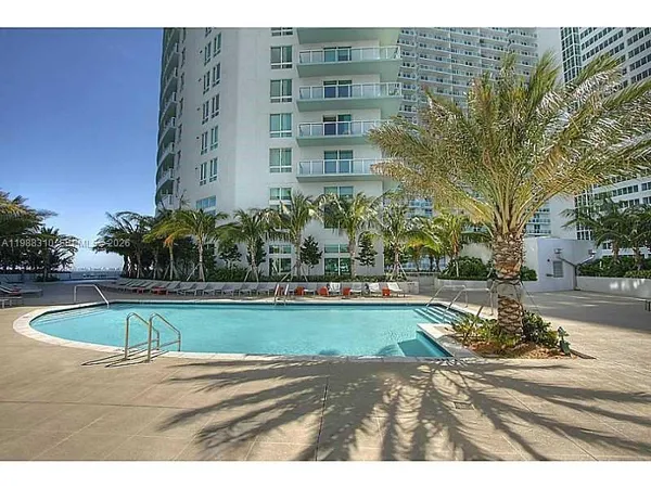 a view of swimming pool with outdoor seating and plants