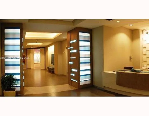 a room with lots of books and a large window