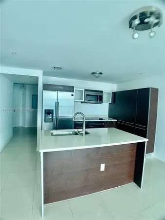 a view of an empty room with cabinet