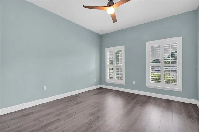 a view of an empty room with wooden floor